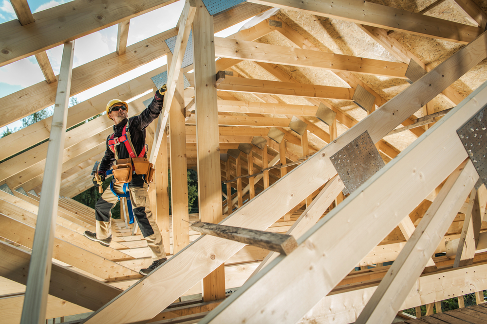 Specialty trade worker inside a wood framed construction project